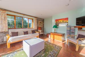 a living room with a couch and a table at Kwerky Cottage in North Lydbury