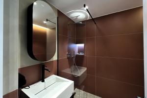 a bathroom with a sink and a mirror at Hotel Bazaar Center in Tirana +48 photos
