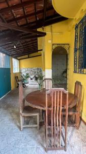 a wooden table and chairs on a patio at Hostel Sol da Barra in Salvador