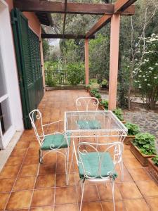 a table and two chairs on a patio at Villa vista mare in Procchio