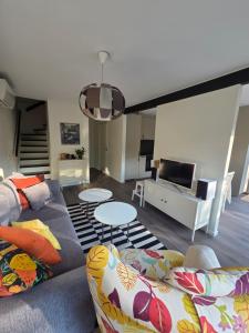 a living room with two couches and a tv at The little house by the paddock - only for non smokers in Gothenburg