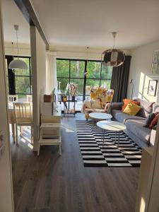 a living room with a couch and a table at The little house by the paddock - only for non smokers in Gothenburg