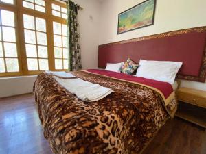 a bedroom with a large bed in a room at Hotel Galaxy Ladakh in Leh
