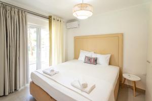 a bedroom with a bed with two towels on it at Oasis Houses Maggana ,Xanthi in Mángana