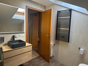 a bathroom with a sink and a mirror at Pilgrim’s House in O Pedrouzo +29 photos