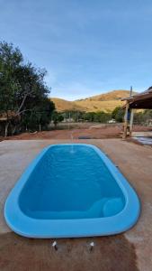 a blue frisbee is sitting on the ground at Hostel Canaã in Itanhandu