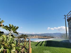 a view from the garden of a house with a swimming pool at Il Casale del Priore in Todi
