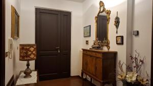a room with a black door and a dresser and a mirror at Il Casale del Priore in Todi +16 photos