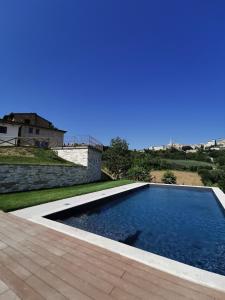 a swimming pool in the backyard of a house at Il Casale del Priore in Todi