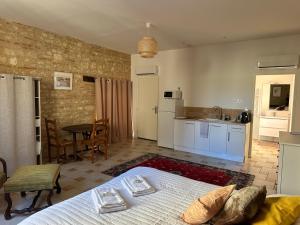 a large bedroom with a bed and a kitchen at château de Mauriac in Senouillac