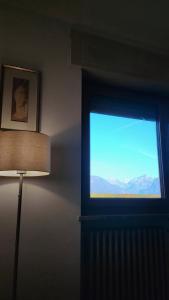 a room with a window with a view of mountains at Casa Vallina - Garden & Mountain View in Castion