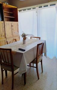 a dining room table with two chairs and a white tablecloth at Alas termas in Termas de Río Hondo