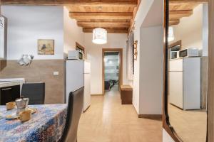 a kitchen and a dining room with a table and chairs at Damiani Case Vacanze Palermo - Centro Storico in Palermo +34 photos