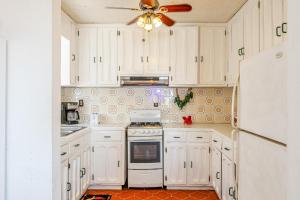 a kitchen with white cabinets and a ceiling fan at Las Mareas #21 in Puerto Peñasco