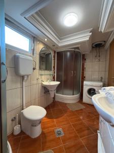 a bathroom with a toilet and a sink at Apartments Nikitenko Meljine in Meljine +13 photos