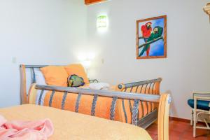 a bedroom with a bed and a painting on the wall at Paradise Villas #16 in Playa Encanto