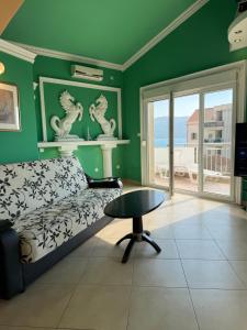 a living room with a couch and a table at Apartments Nikitenko Meljine in Meljine