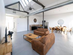 a living room with a couch and a table at Climatisé et atypique, bienvenue au LOFT-23 in Cholet
