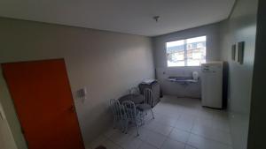a kitchen with a table and chairs and a refrigerator at Apt 402 Ed Nilson Pimentel in Barreiras