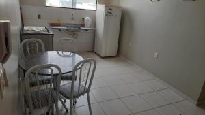 a kitchen with a table and chairs and a refrigerator at Apt 402 Ed Nilson Pimentel in Barreiras