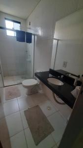 a bathroom with a toilet and a sink at Apt 402 Ed Nilson Pimentel in Barreiras