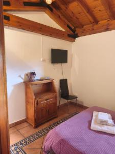 a bedroom with a bed and a desk and a chair at Posada de Serrada in Serrada de la Fuente