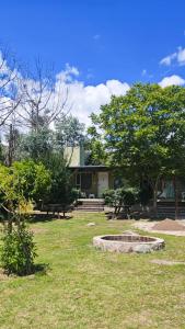 a park with benches and trees and a building at Suite de Lujo Castañitas in Tafí del Valle