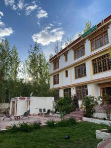 a man standing in front of a large building at Hotel Galaxy Ladakh in Leh +11 photos
