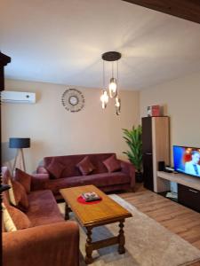 a living room with two couches and a coffee table at Illy Apartament in Gjakove