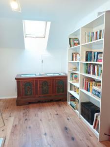 a room with a bed and bookshelves at Gästehaus Stolzalpe in Stolzalpe