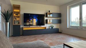 a living room with a large flat screen tv at Haus Sonnenwest in Rosengarten