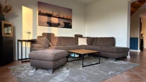 a living room with a couch and a coffee table at Haus Sonnenwest in Rosengarten +26 photos