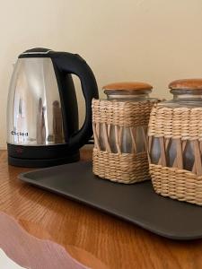 a coffee pot and two baskets on a table at CasaLea in Calcinate
