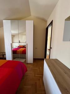 a bedroom with a bed and a mirror at CasaLea in Calcinate