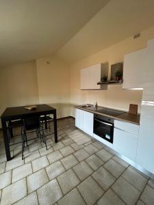 a kitchen with a table and a black table at CasaLea in Calcinate +12 photos