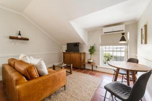 a living room with a couch and a table at Story Haus in Stellenbosch