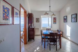a kitchen and dining room with a table and chairs at Creuza de Cinque Terre Apartment in Volastra