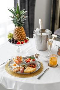 a plate of food on a table with a pineapple at Palacio Suites Marbella in Marbella