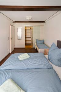 a bedroom with a large blue bed and a couch at Spreezauber in Lübbenau