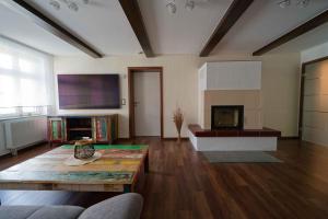 a large living room with a table and a fireplace at Spreezauber in Lübbenau