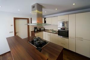 a kitchen with a wooden table and a counter top at Spreezauber in Lübbenau