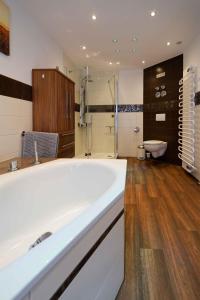 a large bathroom with a tub and a shower at Spreezauber in Lübbenau +16 photos
