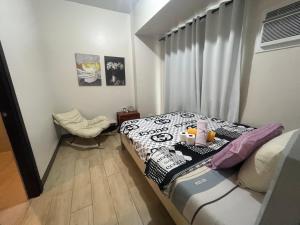 a small bedroom with a bed and a window at GENTRY MANOR fast WiFi,Balcony near Okada,MOA&NAIA 8Q in Manila