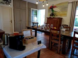 a dining room with a table and chairs and a table sidx sidx at AU PIED DU VENTOUX in Flassan +24 photos