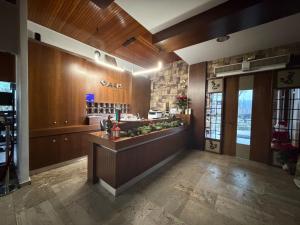 a lobby with a bar in the center of a building at Oasi in Kato Loutraki