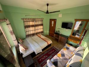 a bedroom with a bed and a tv in it at Hotel Pokhara Paradise in Pokhara