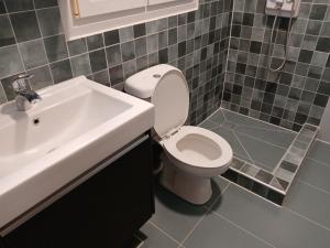 a bathroom with a white toilet and a sink at Magdalena & Bambino apartments in Sarti +23 photos