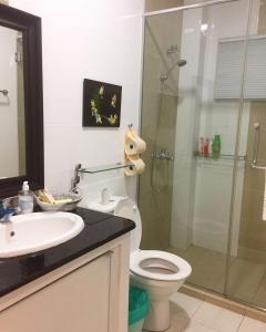 a bathroom with a shower and a toilet and a sink at Crystal Cameron Vacation Bungalow in Cameron Highlands