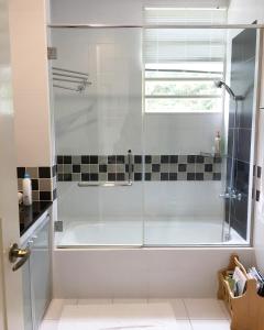 a shower with a glass door in a bathroom at Crystal Cameron Vacation Bungalow in Cameron Highlands