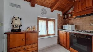 a kitchen with wooden cabinets and a window at Il Rifugio nelle Stelle in Agerola